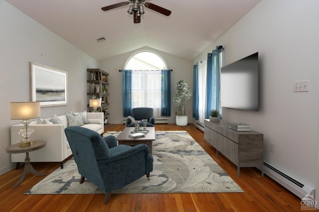 living area with lofted ceiling, a baseboard radiator, baseboard heating, and wood finished floors