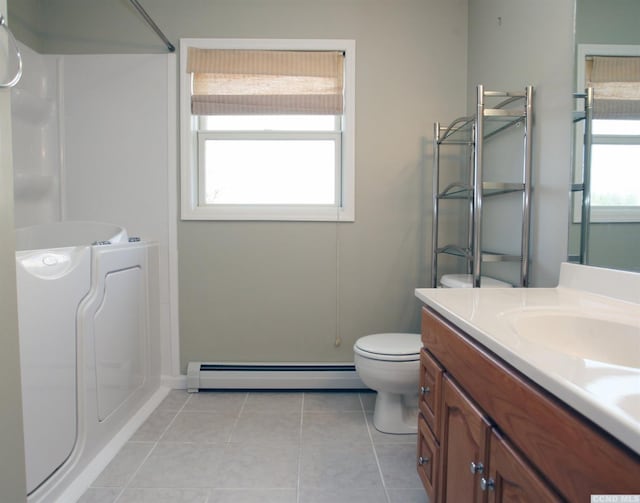 bathroom featuring tile patterned flooring, toilet, vanity, a shower, and baseboard heating