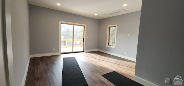 spare room with hardwood / wood-style flooring