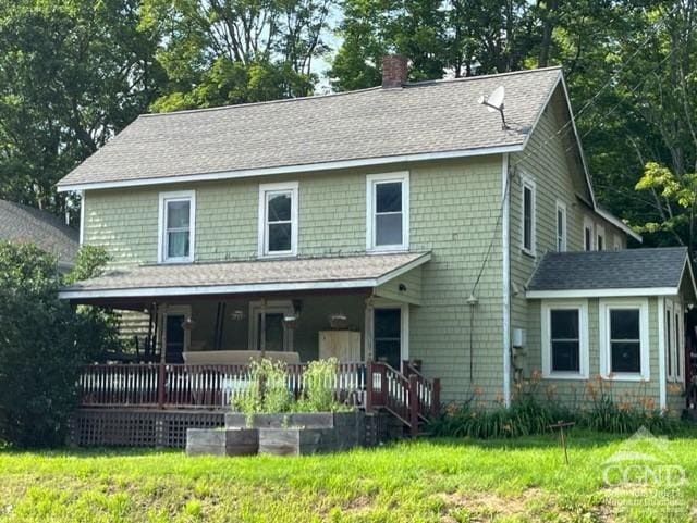 view of front of home featuring a front lawn and a porch