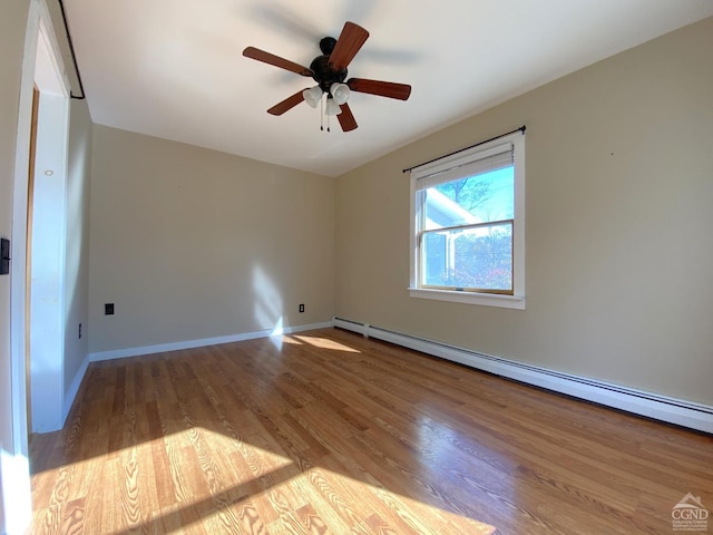 empty room featuring ceiling fan, light hardwood / wood-style flooring, and a baseboard radiator