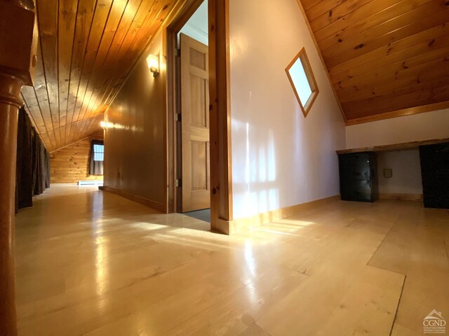 bonus room with lofted ceiling, wood walls, and wooden ceiling