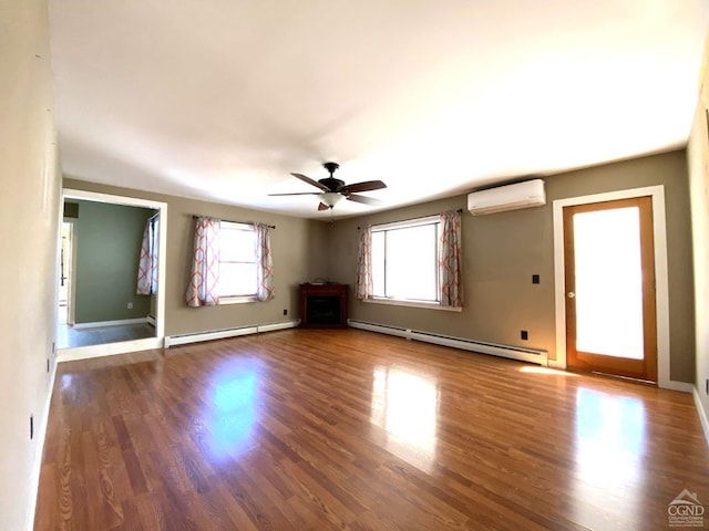 interior space featuring a wall unit AC, ceiling fan, dark hardwood / wood-style flooring, and a baseboard heating unit