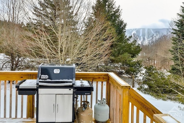 snow covered deck featuring a mountain view