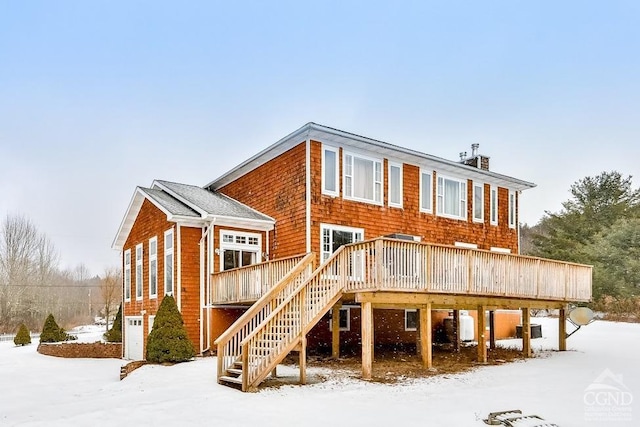 snow covered property featuring a wooden deck