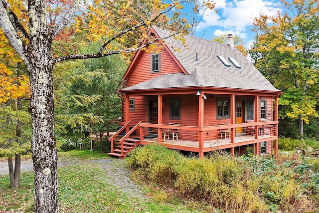 rear view of property featuring a wooden deck