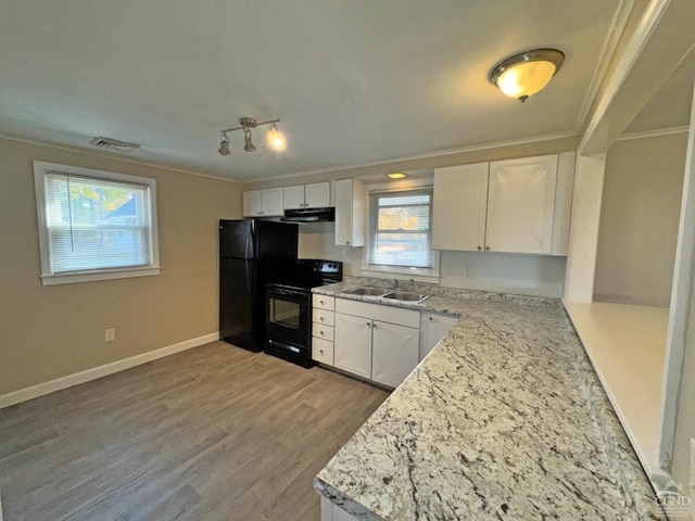 kitchen featuring light stone countertops, sink, white cabinets, black appliances, and ornamental molding