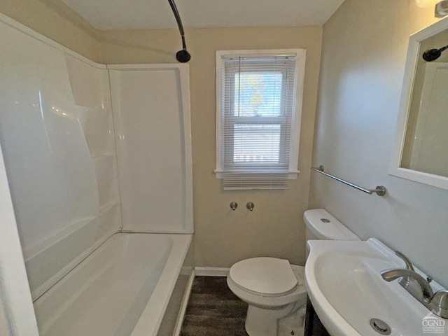 bathroom with wood-type flooring, toilet, and sink