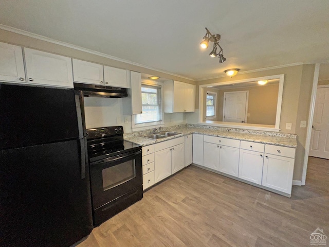 kitchen with black appliances, white cabinets, sink, and light hardwood / wood-style flooring