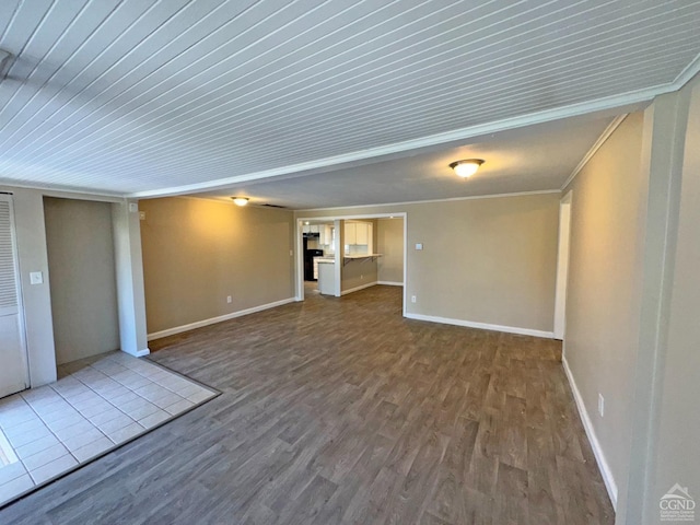 unfurnished living room featuring hardwood / wood-style flooring and ornamental molding