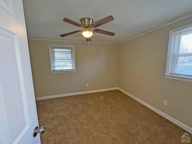 carpeted empty room featuring ceiling fan and ornamental molding