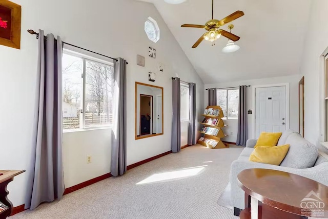 living area with high vaulted ceiling, a ceiling fan, baseboards, and light carpet