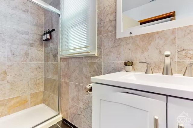 bathroom featuring vanity, tile walls, and a stall shower