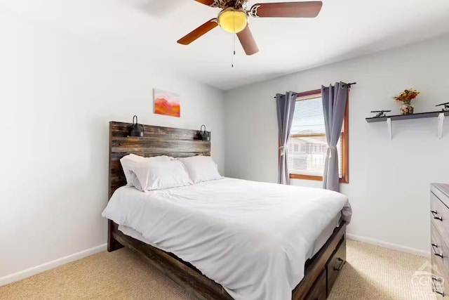 bedroom with light colored carpet, baseboards, and ceiling fan