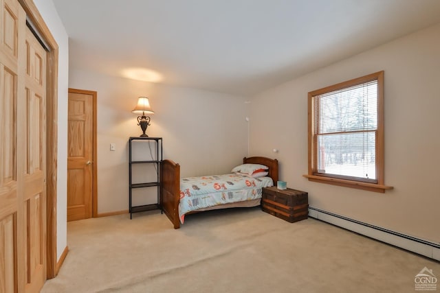 bedroom featuring a closet, light colored carpet, and a baseboard radiator