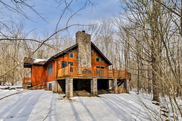 snow covered property featuring a wooden deck