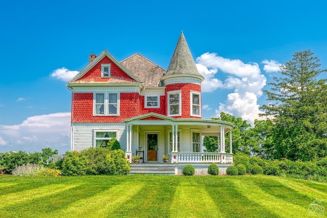 victorian house with a porch and a front yard