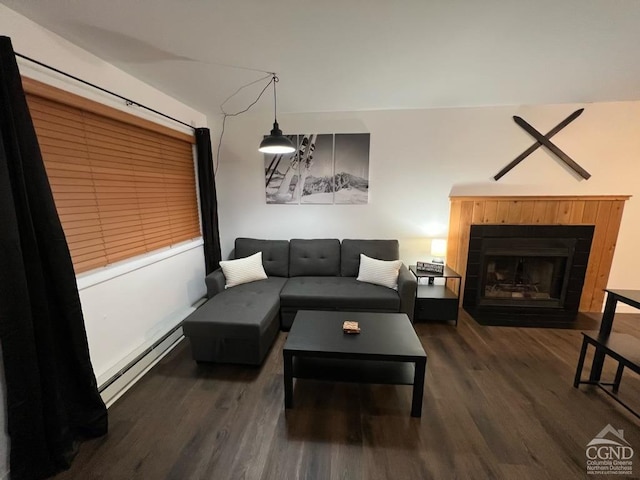 living room with a baseboard heating unit and dark wood-type flooring