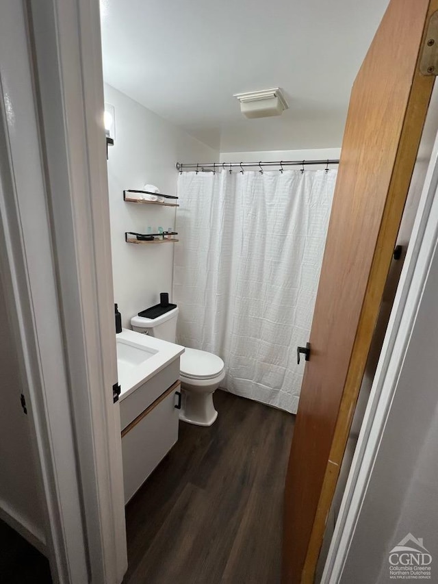 bathroom featuring hardwood / wood-style floors, vanity, and toilet