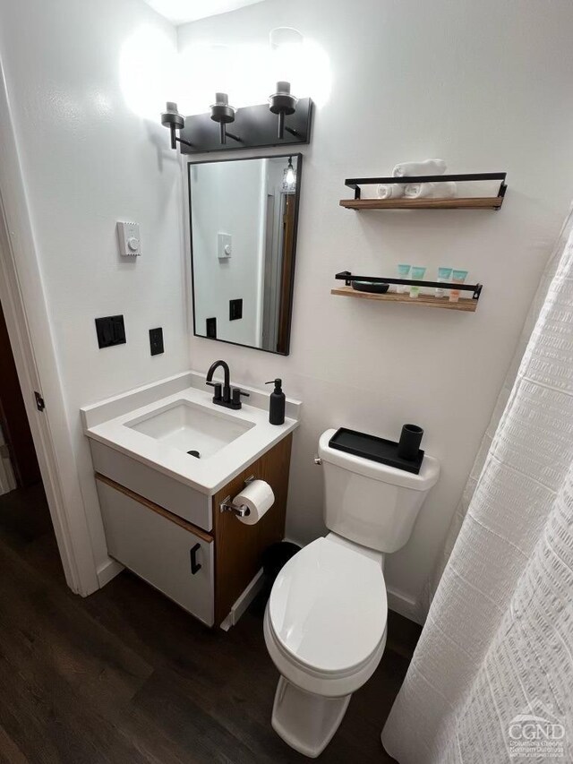 bathroom featuring hardwood / wood-style flooring, vanity, and toilet