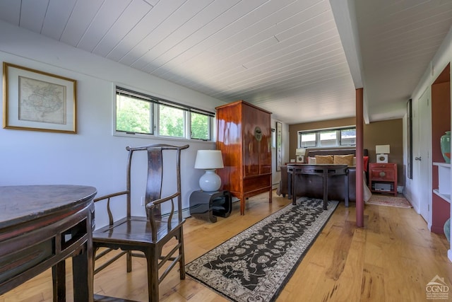 interior space with baseboard heating, light wood-type flooring, and wood ceiling