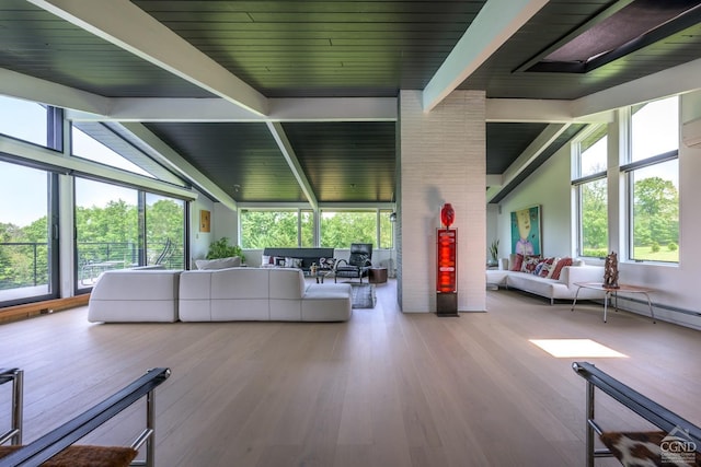 unfurnished living room featuring high vaulted ceiling, a wealth of natural light, beamed ceiling, and wood finished floors