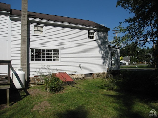 view of side of property with a yard