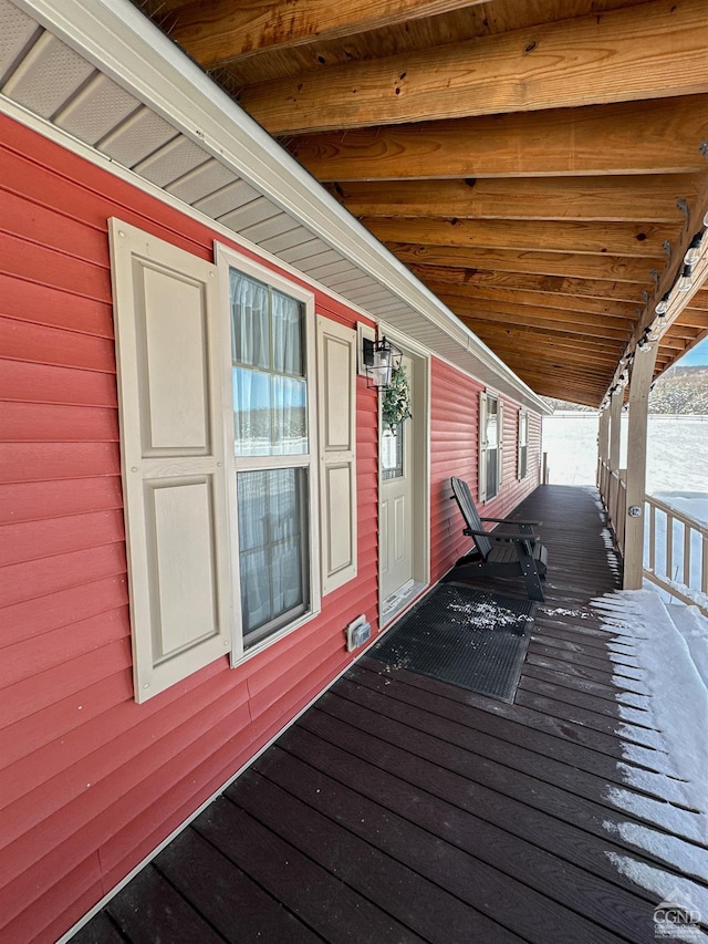 wooden terrace featuring covered porch