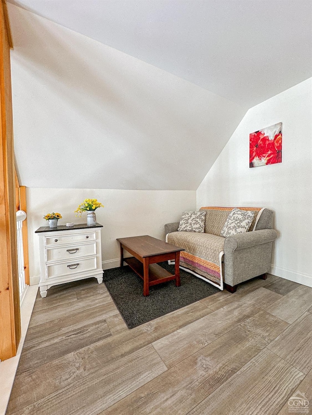 sitting room featuring lofted ceiling and hardwood / wood-style flooring