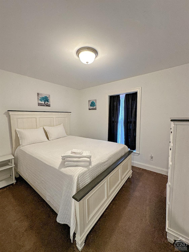 bedroom featuring dark carpet