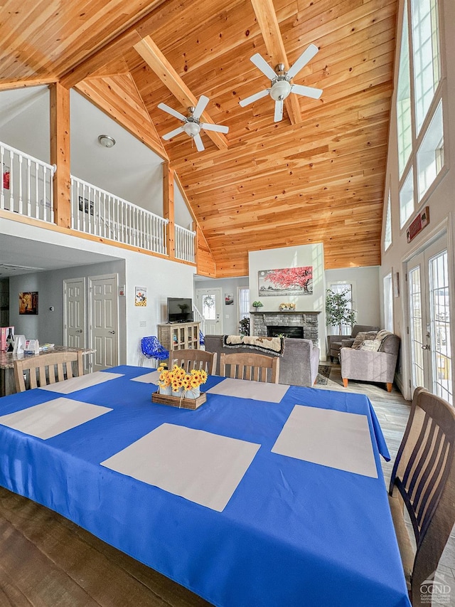 dining room featuring beam ceiling, ceiling fan, french doors, high vaulted ceiling, and hardwood / wood-style floors