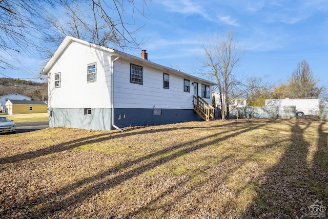 view of side of property with a lawn