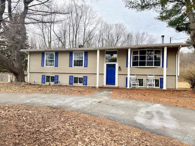 bi-level home featuring aphalt driveway