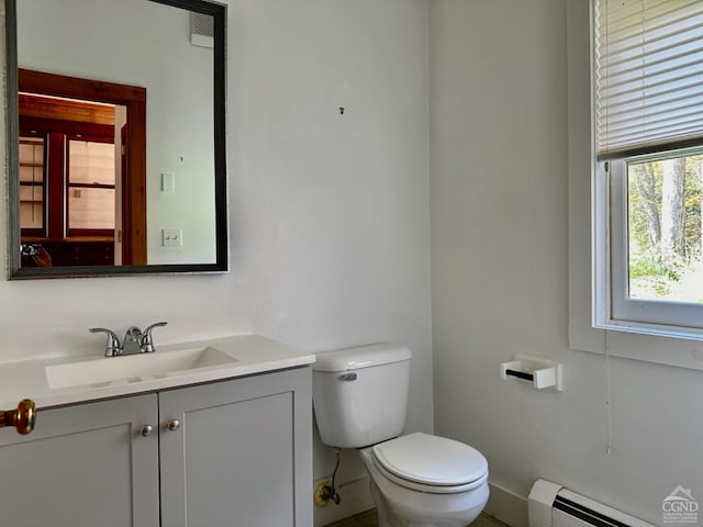 bathroom featuring vanity, toilet, and a baseboard radiator