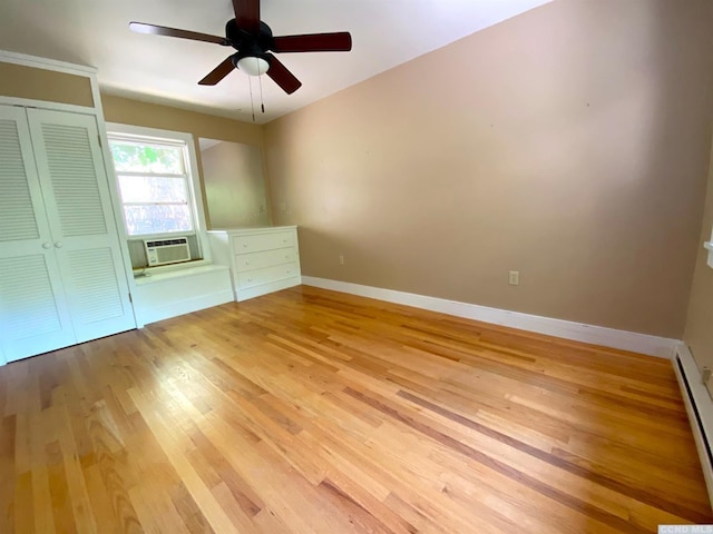 unfurnished bedroom with cooling unit, ceiling fan, a baseboard radiator, light hardwood / wood-style floors, and a closet