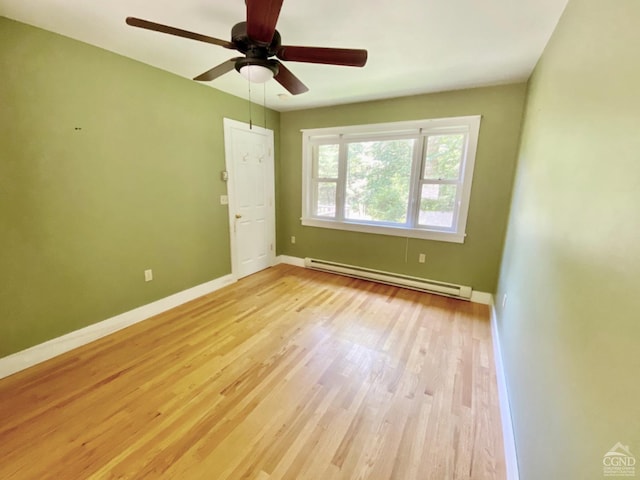 unfurnished room featuring ceiling fan, light wood-type flooring, and baseboard heating