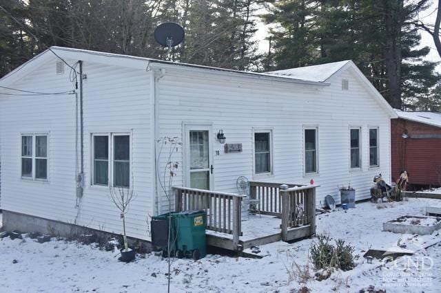 view of snow covered rear of property