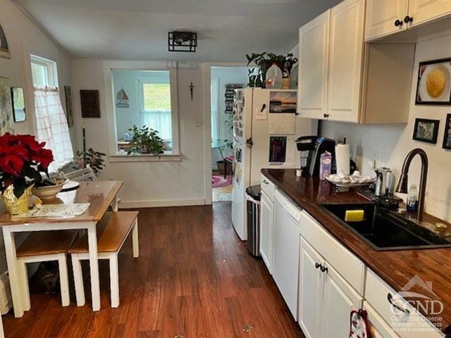 kitchen featuring dishwasher, dark hardwood / wood-style flooring, white cabinetry, and sink