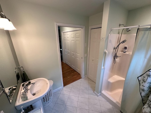 bathroom featuring hardwood / wood-style flooring, sink, and walk in shower