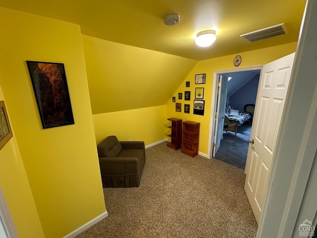 living area with carpet and vaulted ceiling