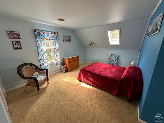 bedroom featuring carpet floors and lofted ceiling with skylight