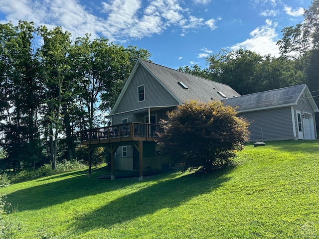 back of property featuring a deck and a yard