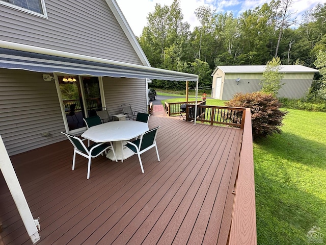 wooden deck featuring an outdoor structure and a yard