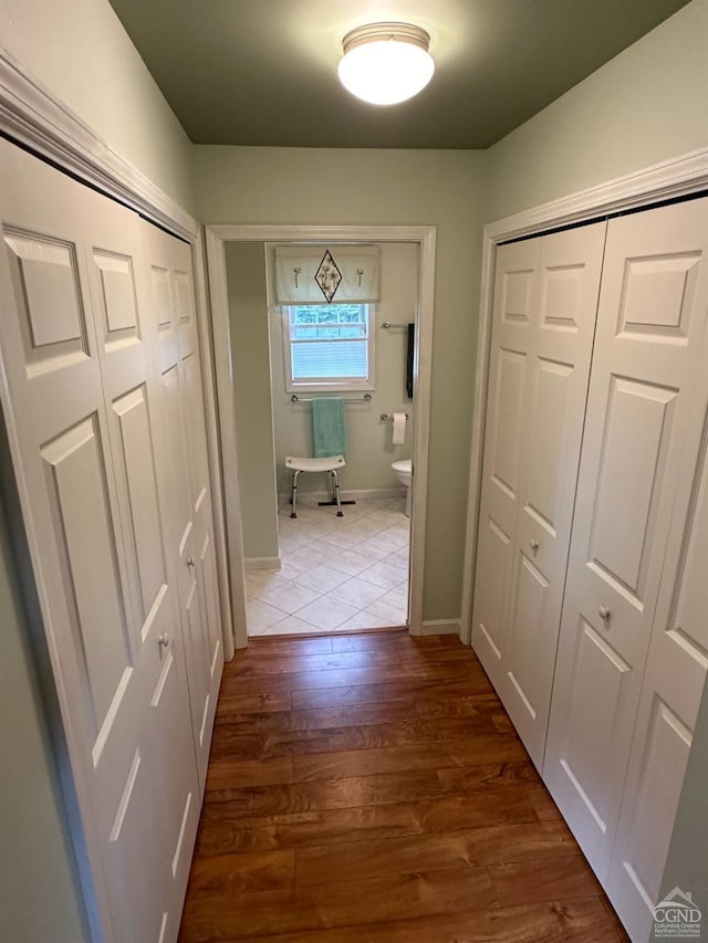 hallway with wood-type flooring