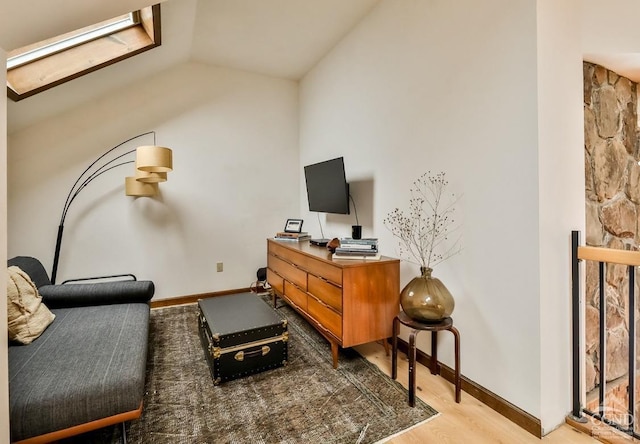 living area with light hardwood / wood-style floors and vaulted ceiling