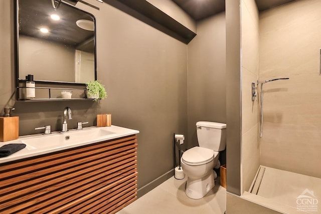 bathroom featuring tile patterned flooring, vanity, toilet, and walk in shower