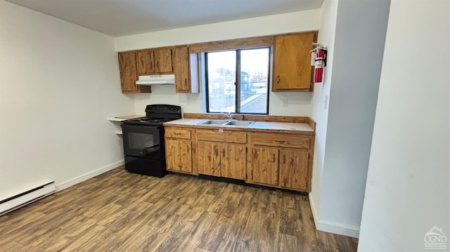 kitchen with black / electric stove, light countertops, under cabinet range hood, a baseboard heating unit, and a sink