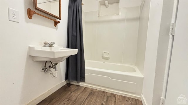 full bathroom featuring shower / bathtub combination with curtain, baseboards, and wood finished floors