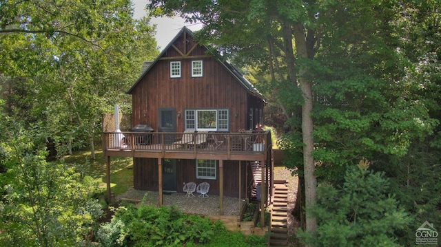 rear view of house featuring a wooden deck