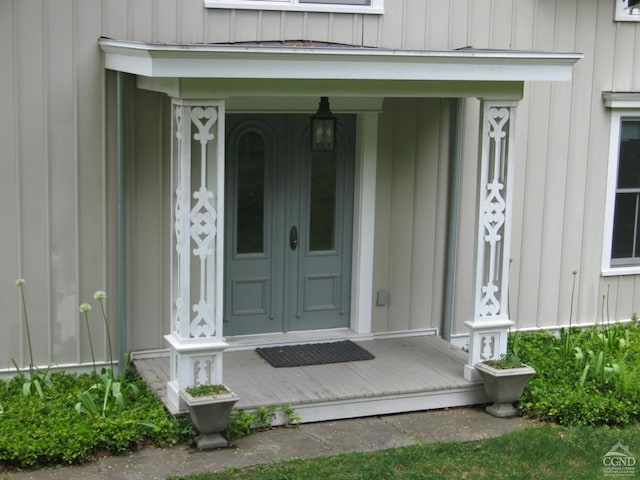 doorway to property featuring a porch and board and batten siding